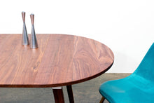 Load image into Gallery viewer, Minimalist Modern Dining Table with Angled Legs. Handmade of Solid Wood and Powder Coated Metal. Available in Walnut, Oak or Ash with Oval or Rectangular Top. Custom Paint Colors Available.