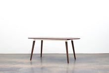 Load image into Gallery viewer, Minimalist Modern Dining Table with Angled Legs. Handmade of Solid Wood and Powder Coated Metal. Available in Walnut, Oak or Ash with Oval or Rectangular Top. Custom Paint Colors Available.