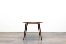 Load image into Gallery viewer, Minimalist Modern Dining Table with Angled Legs. Handmade of Solid Wood and Powder Coated Metal. Available in Walnut, Oak or Ash with Oval or Rectangular Top. Custom Paint Colors Available.