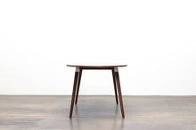Load image into Gallery viewer, Minimalist Modern Dining Table with Angled Legs. Handmade of Solid Wood and Powder Coated Metal. Available in Walnut, Oak or Ash with Oval or Rectangular Top. Custom Paint Colors Available.
